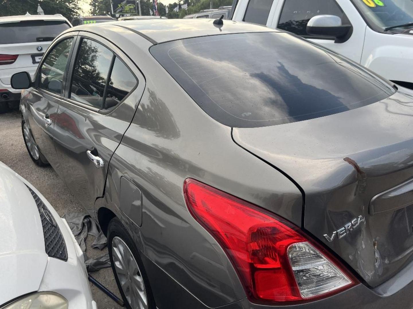 2012 BROWN NISSAN VERSA 1.6 S Sedan (3N1CN7AP4CL) with an 1.6L L4 DOHC 16V engine, AUTOMATIC transmission, located at 2303 West Mt. Houston, Houston, Texas, 77038, (281) 507-3956, 29.771597, -95.339569 - Photo#1