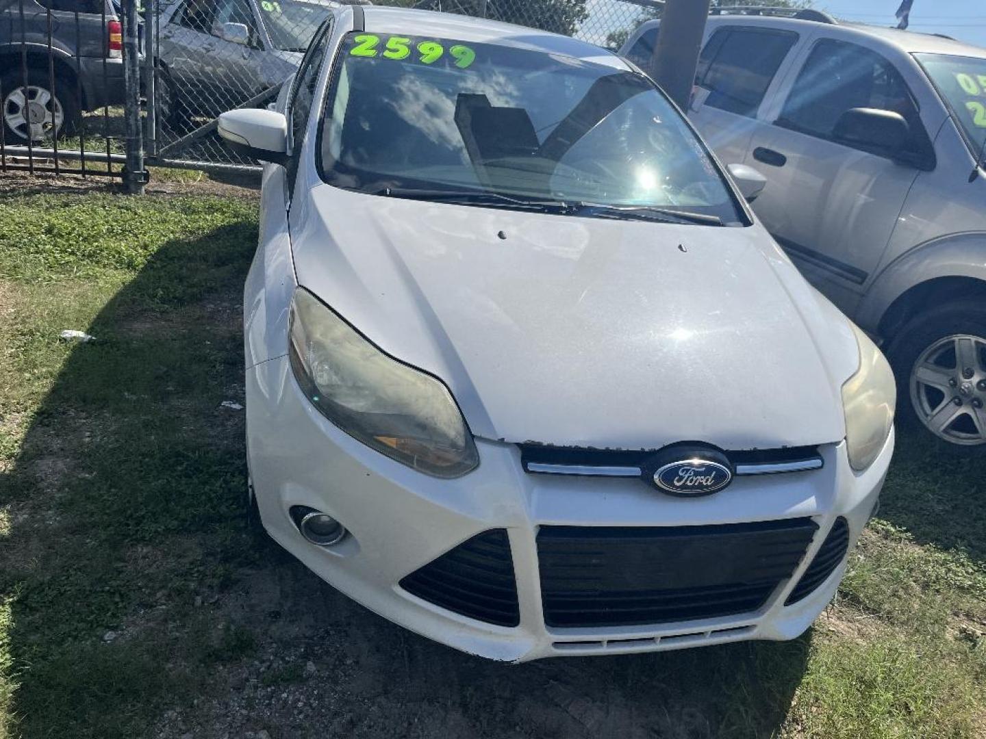 2014 WHITE FORD FOCUS Titanium Sedan (1FADP3J21EL) with an 2.0L L4 DOHC 16V engine, AUTOMATIC transmission, located at 2303 West Mt. Houston, Houston, Texas, 77038, (281) 507-3956, 29.771597, -95.339569 - Photo#1