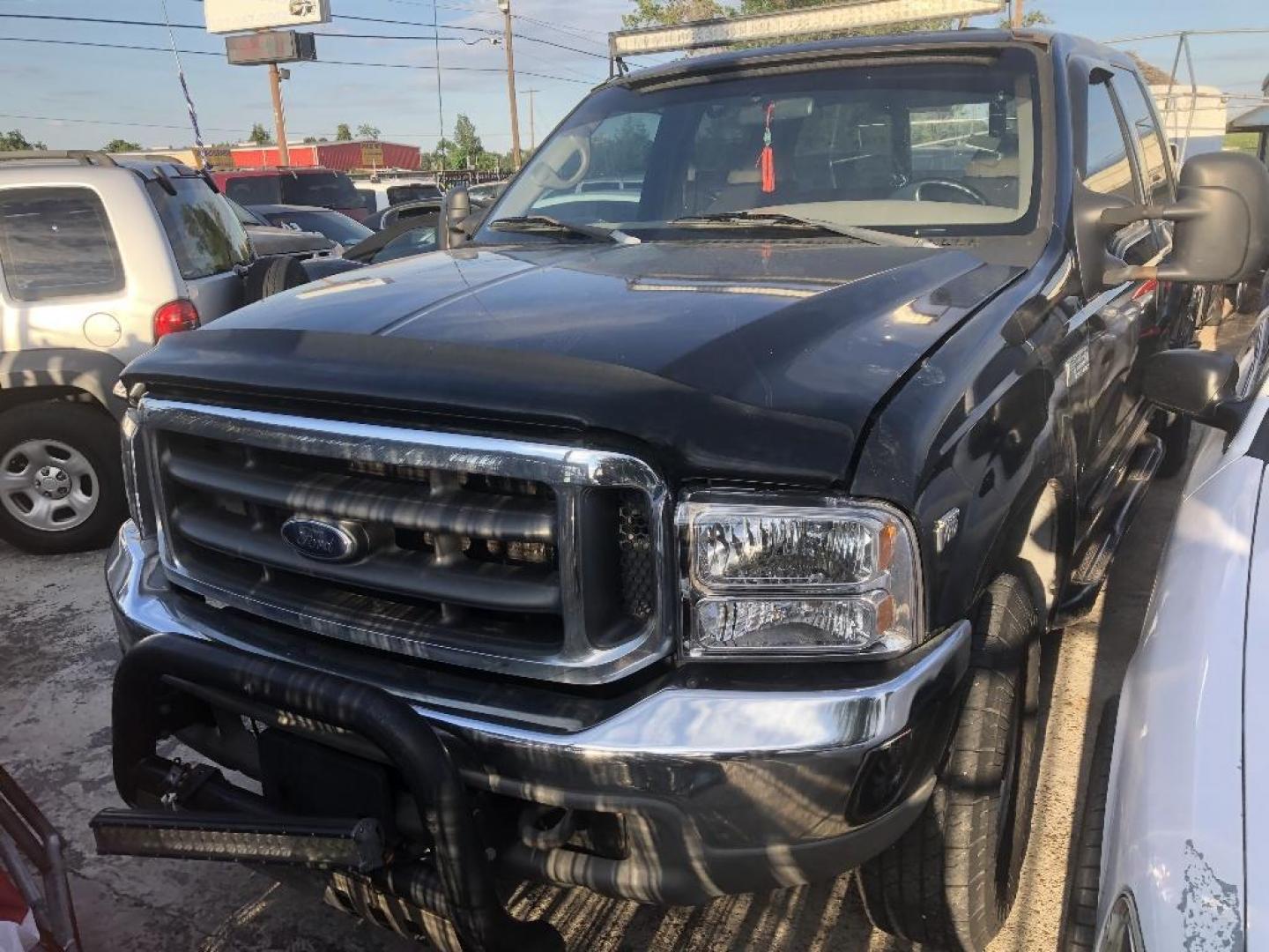 1999 BLACK FORD F-250 SD XLT Crew Cab SWB 4WD (1FTNW21S1XE) with an 6.8L V10 SOHC 20V engine, AUTOMATIC transmission, located at 2303 West Mt. Houston, Houston, Texas, 77038, (281) 507-3956, 29.771597, -95.339569 - Photo#0