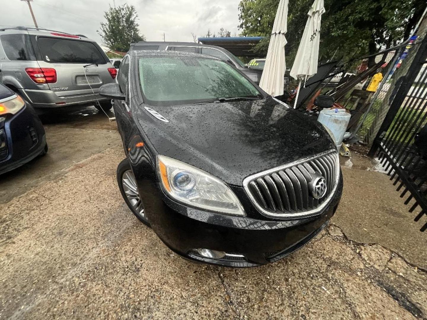 2013 BLACK BUICK VERANO Leather (1G4PS5SK3D4) with an 2.4L L4 DOHC 16V FFV engine, AUTOMATIC transmission, located at 2303 West Mt. Houston, Houston, Texas, 77038, (281) 507-3956, 29.771597, -95.339569 - Photo#0