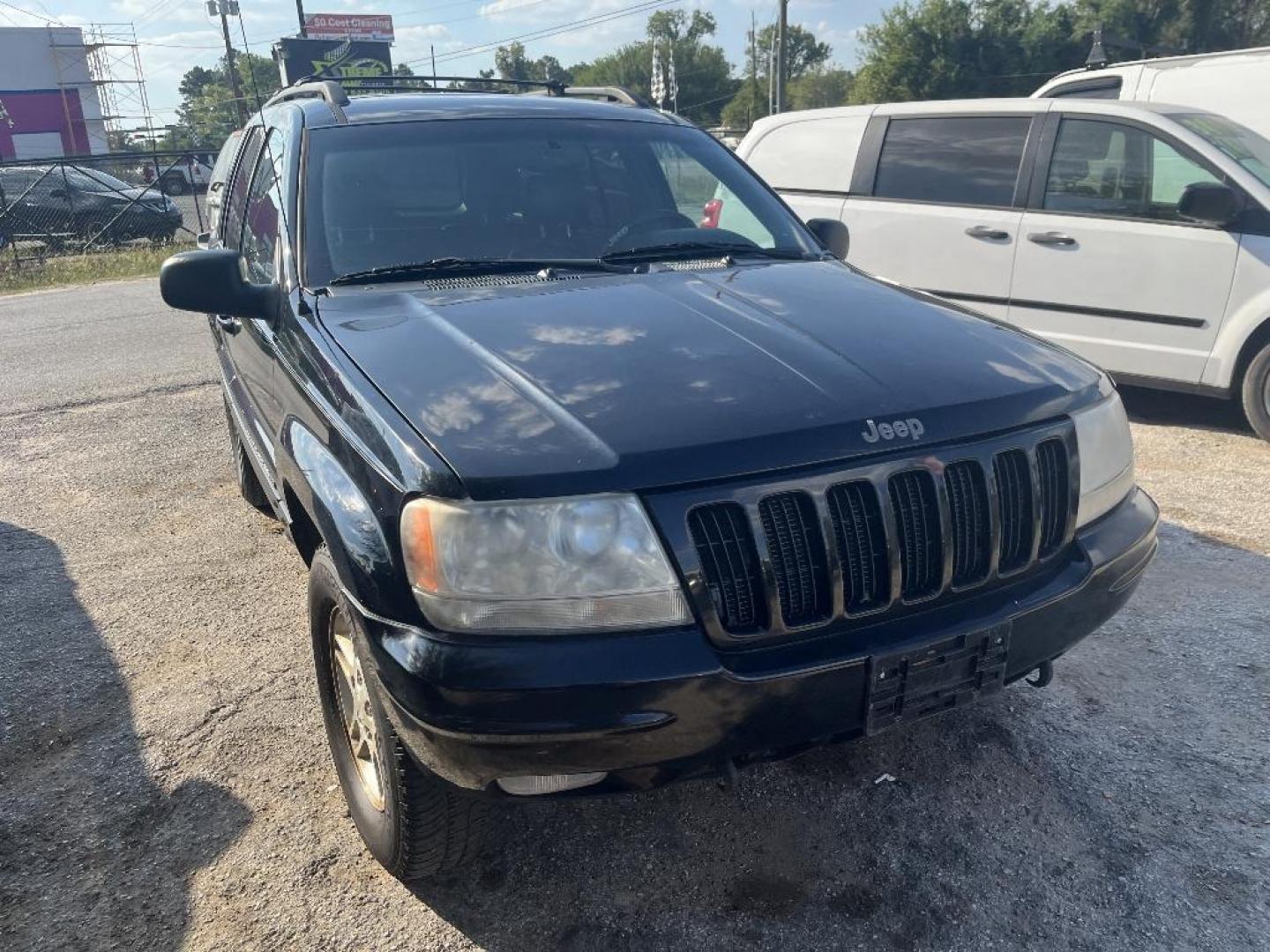 2000 BLACK JEEP GRAND CHEROKEE Limited 4WD (1J4GW58N0YC) with an 4.7L V8 SOHC 16V engine, AUTOMATIC transmission, located at 2303 West Mt. Houston, Houston, Texas, 77038, (281) 507-3956, 29.771597, -95.339569 - Photo#0