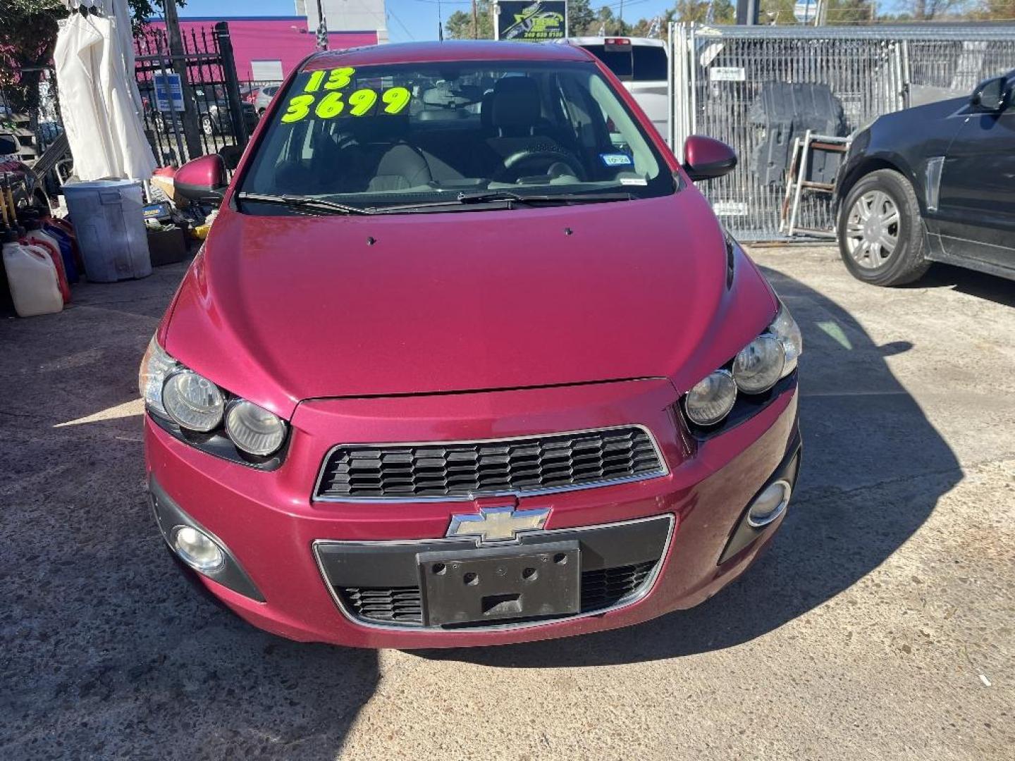 2014 RED CHEVROLET SONIC LT Auto Sedan (1G1JC5SH5E4) with an 1.8L L4 DOHC 24V engine, AUTOMATIC transmission, located at 2303 West Mt. Houston, Houston, 77038, (281) 507-3956, 29.771597, -95.339569 - Photo#0