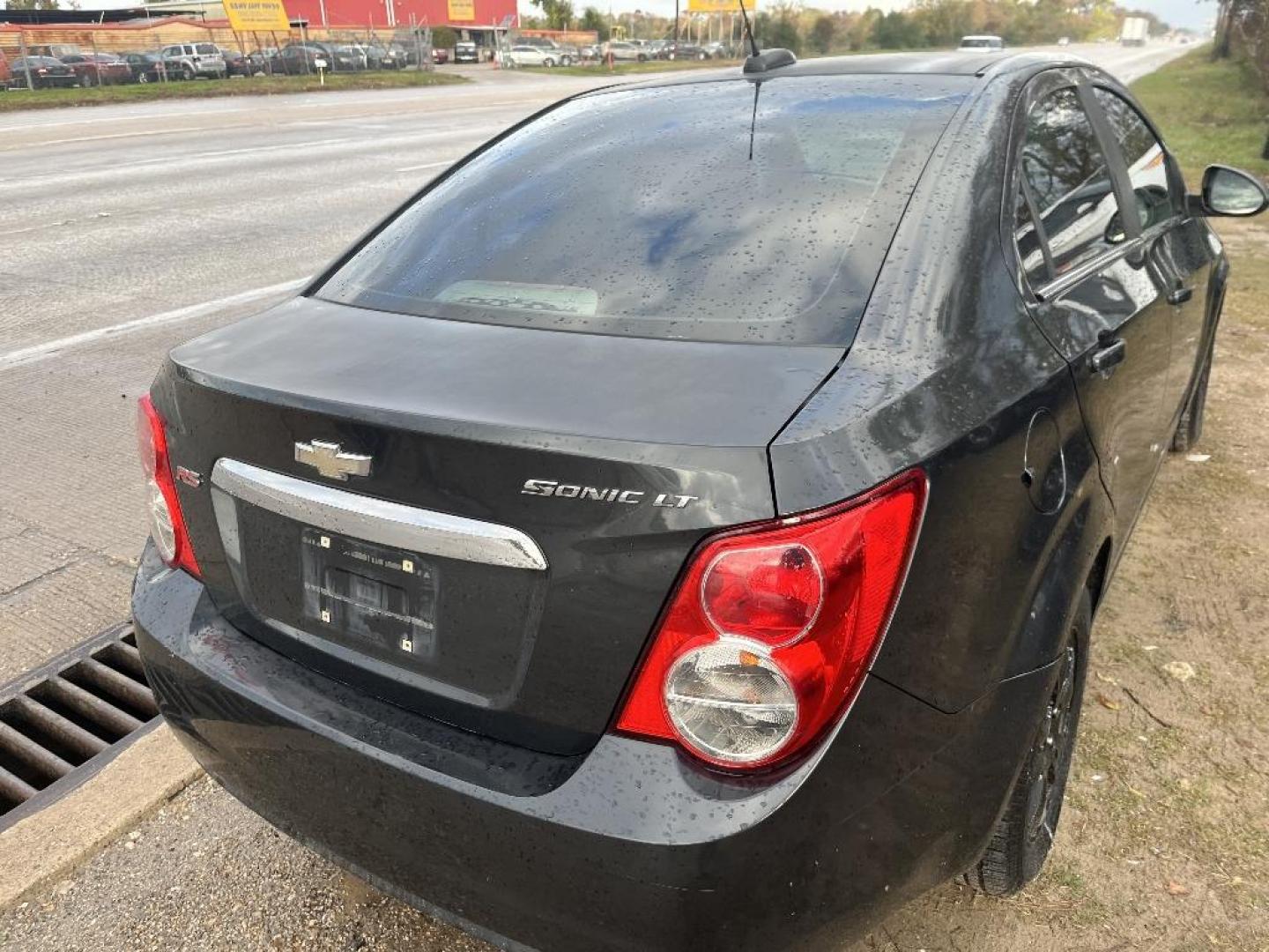 2015 BLACK CHEVROLET SONIC LT Auto Sedan (1G1JC5SH0F4) with an 1.8L L4 DOHC 24V engine, AUTOMATIC transmission, located at 2303 West Mt. Houston, Houston, 77038, (281) 507-3956, 29.771597, -95.339569 - Photo#2