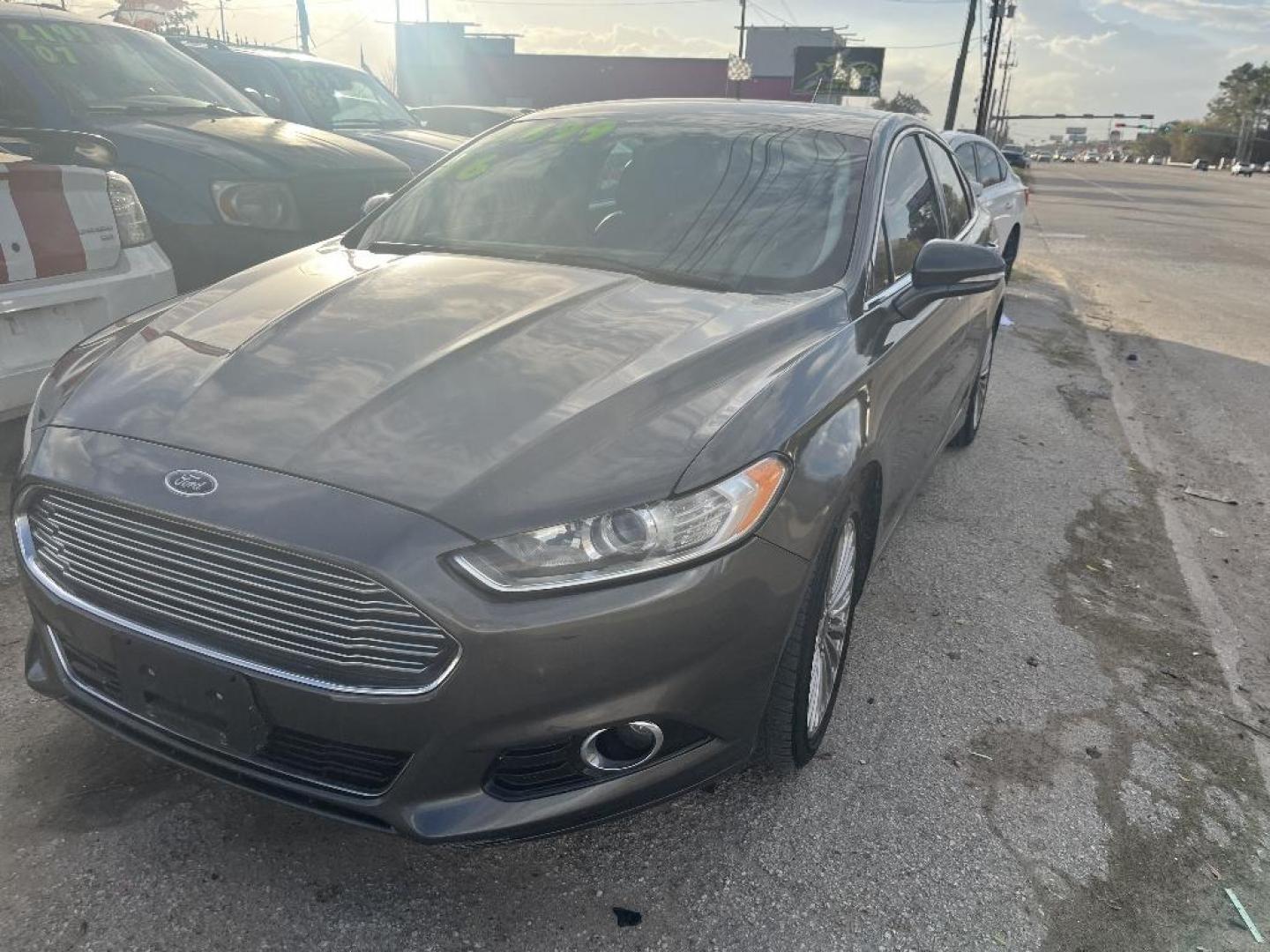 2016 GRAY FORD FUSION Titanium (3FA6P0K97GR) with an 2.0L L4 DOHC 16V engine, AUTOMATIC transmission, located at 2303 West Mt. Houston, Houston, 77038, (281) 507-3956, 29.771597, -95.339569 - Photo#0