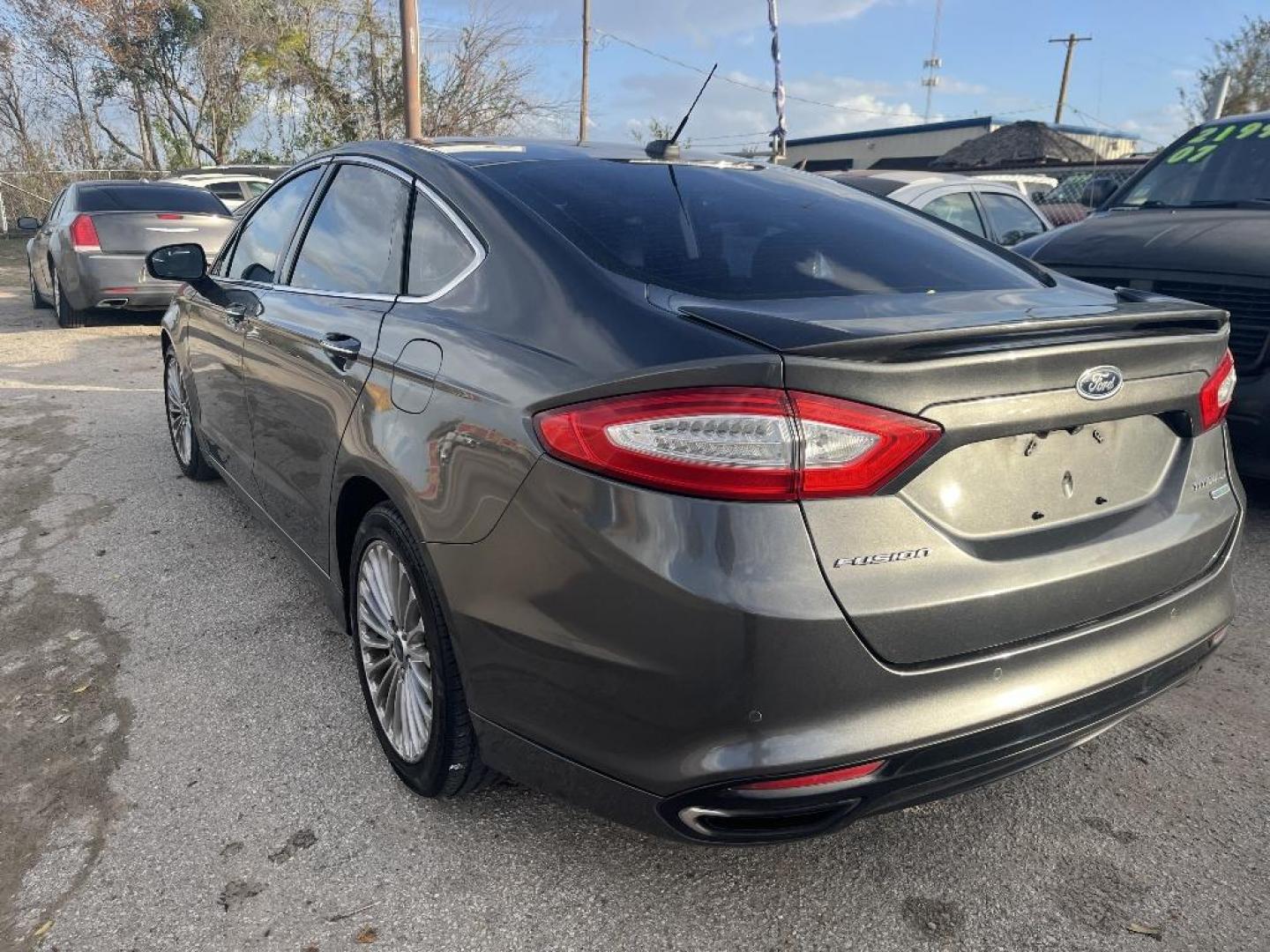 2016 GRAY FORD FUSION Titanium (3FA6P0K97GR) with an 2.0L L4 DOHC 16V engine, AUTOMATIC transmission, located at 2303 West Mt. Houston, Houston, 77038, (281) 507-3956, 29.771597, -95.339569 - Photo#1