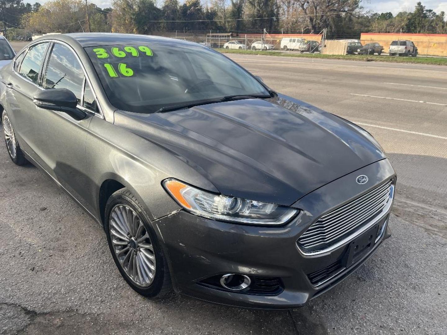 2016 GRAY FORD FUSION Titanium (3FA6P0K97GR) with an 2.0L L4 DOHC 16V engine, AUTOMATIC transmission, located at 2303 West Mt. Houston, Houston, 77038, (281) 507-3956, 29.771597, -95.339569 - Photo#2