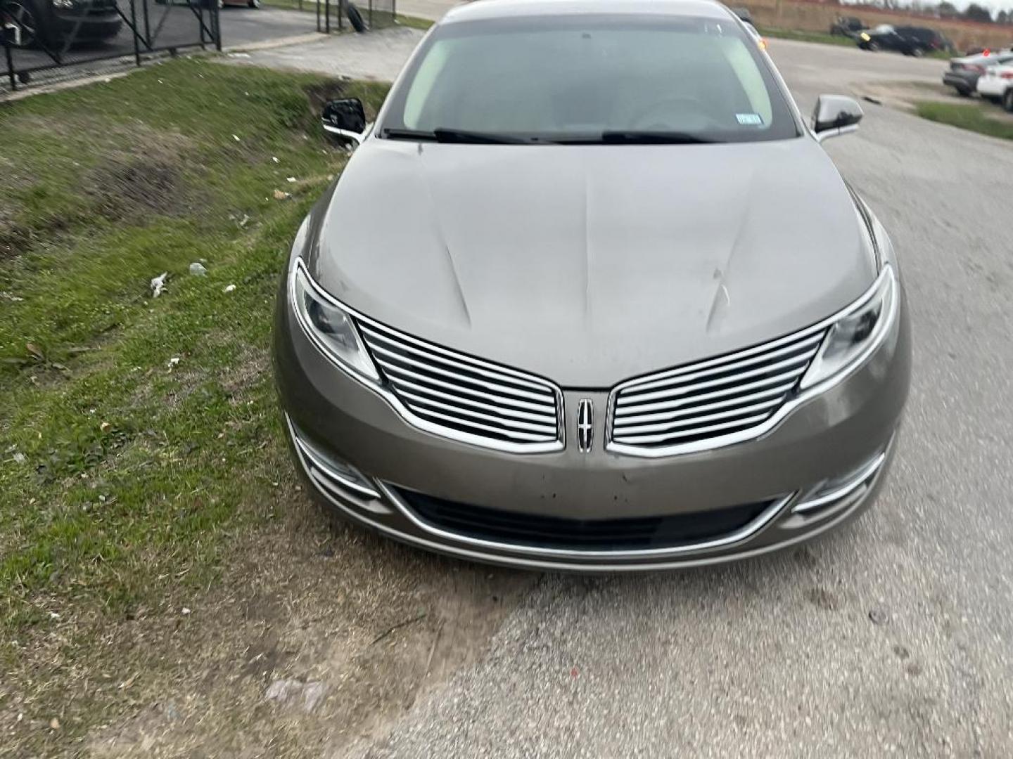 2015 BROWN LINCOLN MKZ HYBRID Sedan (3LN6L2LU0FR) with an 2.0L L4 DOHC 16V HYBRID engine, AUTOMATIC transmission, located at 2303 West Mt. Houston, Houston, 77038, (281) 507-3956, 29.771597, -95.339569 - Photo#0