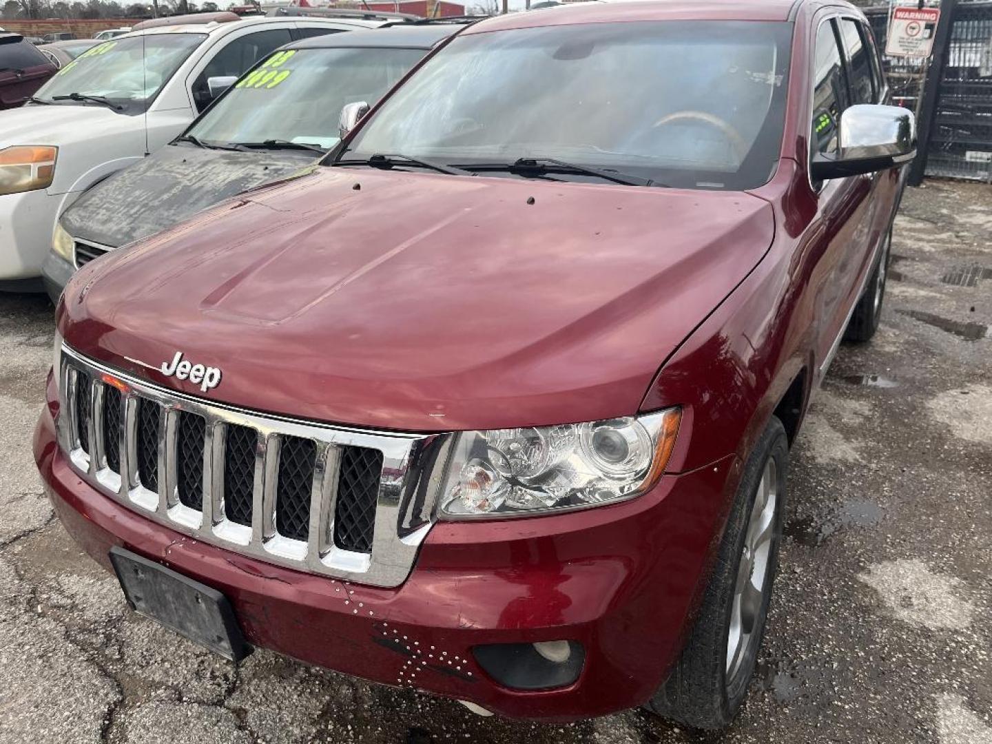 2013 MAROON JEEP GRAND CHEROKEE Overland 2WD (1C4RJECT4DC) with an 5.7L V8 OHV 16V engine, AUTOMATIC transmission, located at 2303 West Mt. Houston, Houston, 77038, (281) 507-3956, 29.771597, -95.339569 - Photo#1