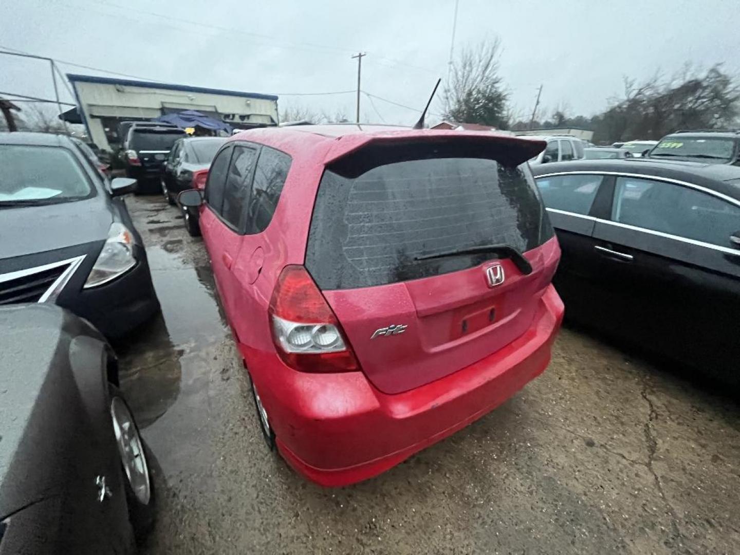 2007 RED HONDA FIT Sport 5-Speed AT (JHMGD38667S) with an 1.5L L4 SOHC 16V engine, AUTOMATIC transmission, located at 2303 West Mt. Houston, Houston, 77038, (281) 507-3956, 29.771597, -95.339569 - Photo#1