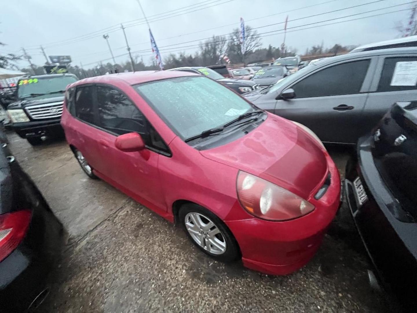 2007 RED HONDA FIT Sport 5-Speed AT (JHMGD38667S) with an 1.5L L4 SOHC 16V engine, AUTOMATIC transmission, located at 2303 West Mt. Houston, Houston, 77038, (281) 507-3956, 29.771597, -95.339569 - Photo#2